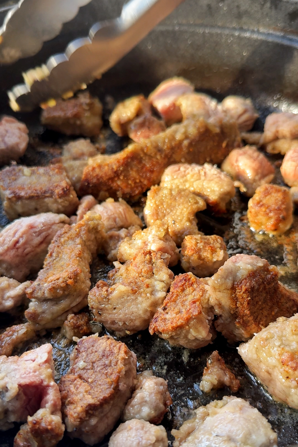 Frying beef in a pan.