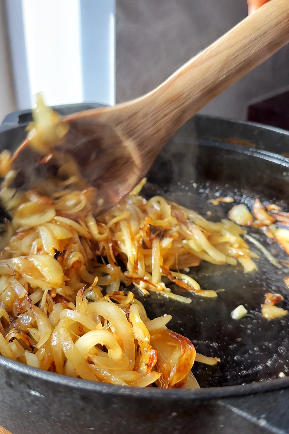 Caramelised onions in a casserole dish with garlic.