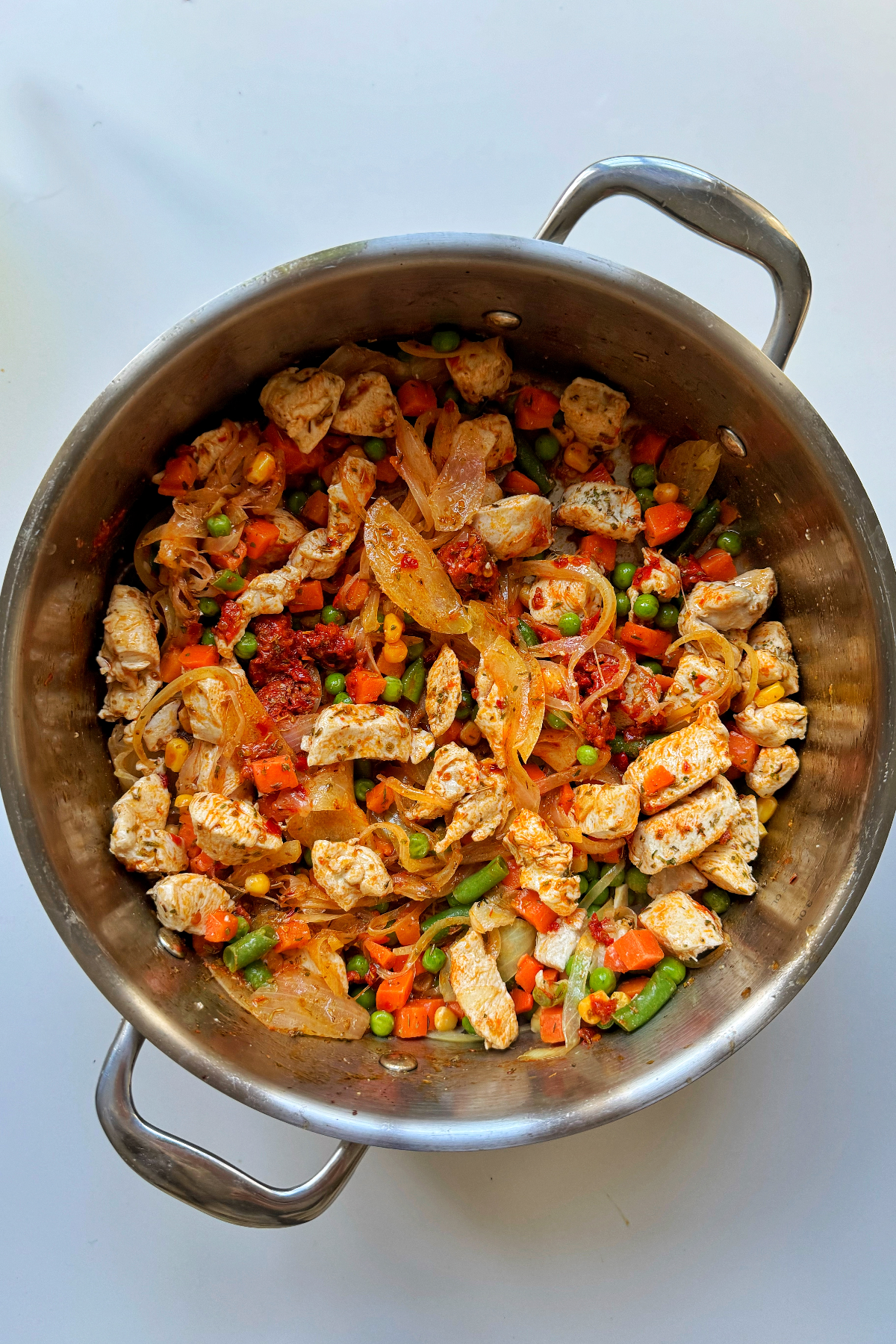 Adding seasonings to our chicken pot pie mixture.