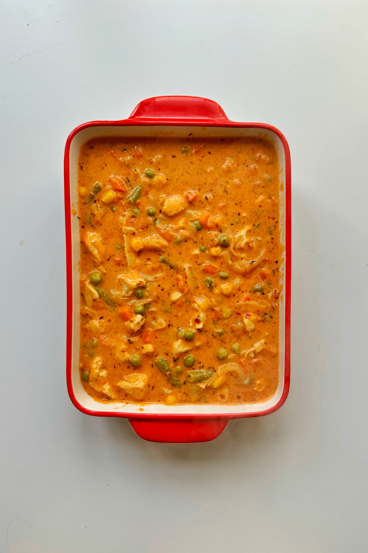 Chicken pot pie gravy in a 9 by 7 inch dish.