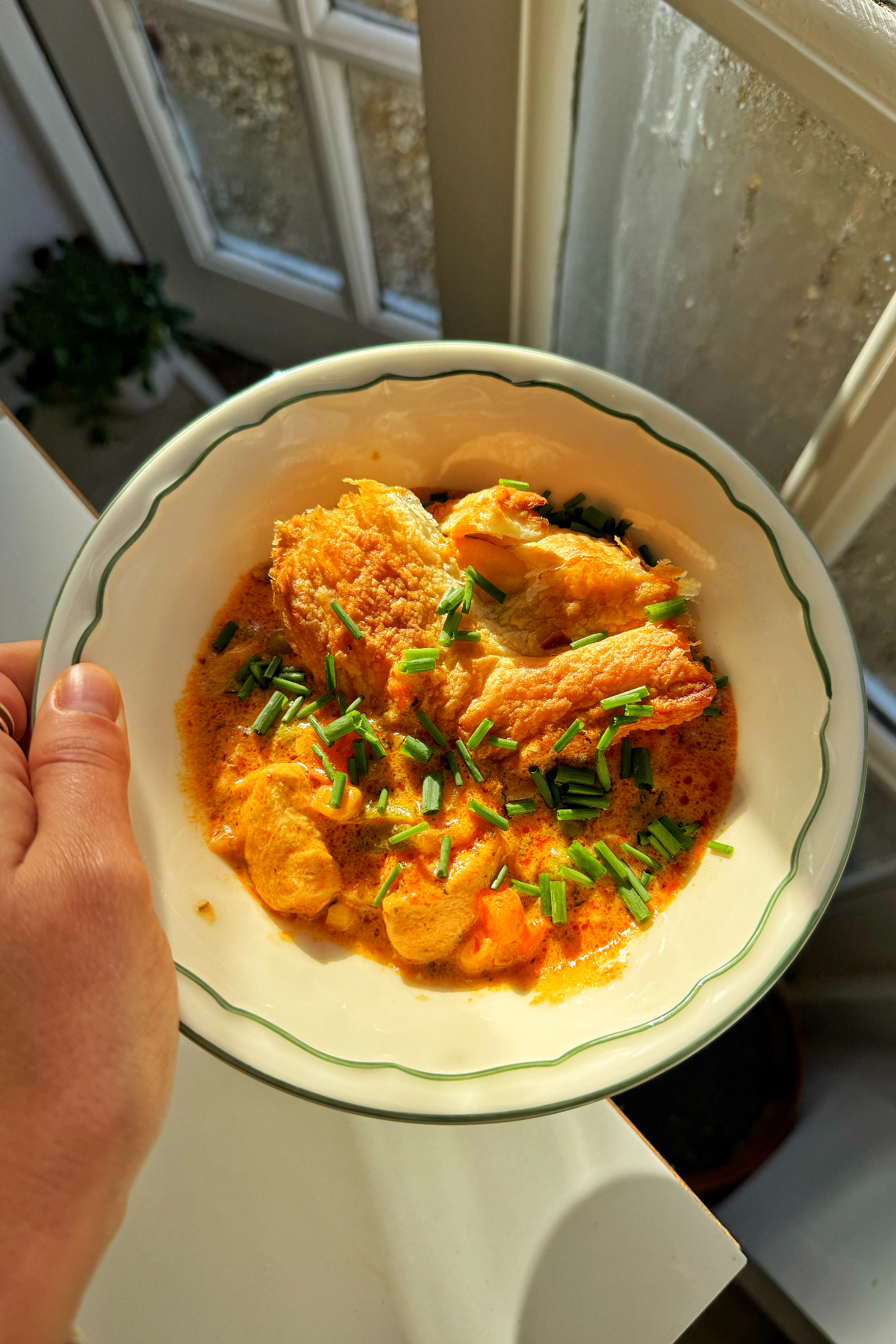 A bowl of chicken pot pie using puff pastry.