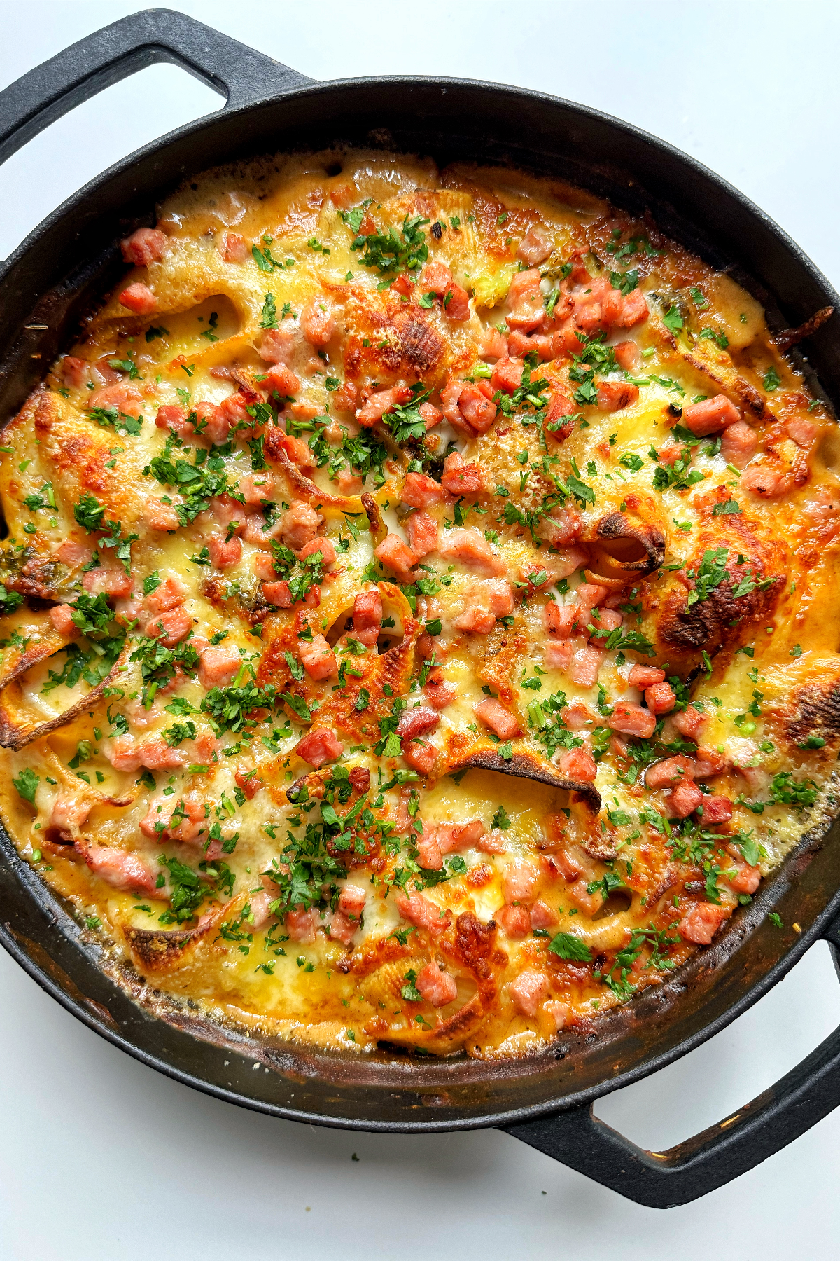 Chicken and broccoli pasta bake in a black casserole dish.