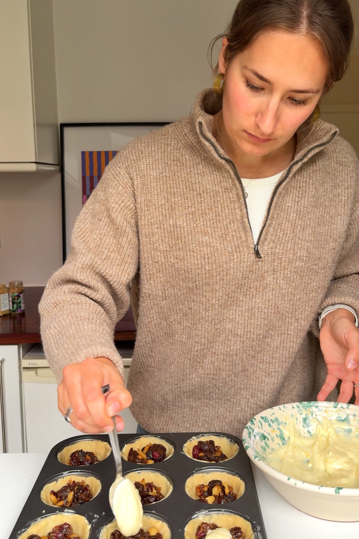 Dividing the filling into the mince pie cases.