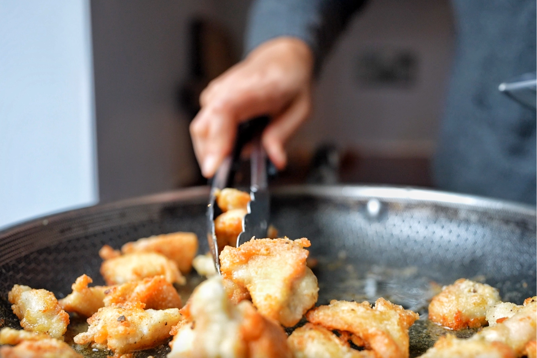 Removing chicken from pan.