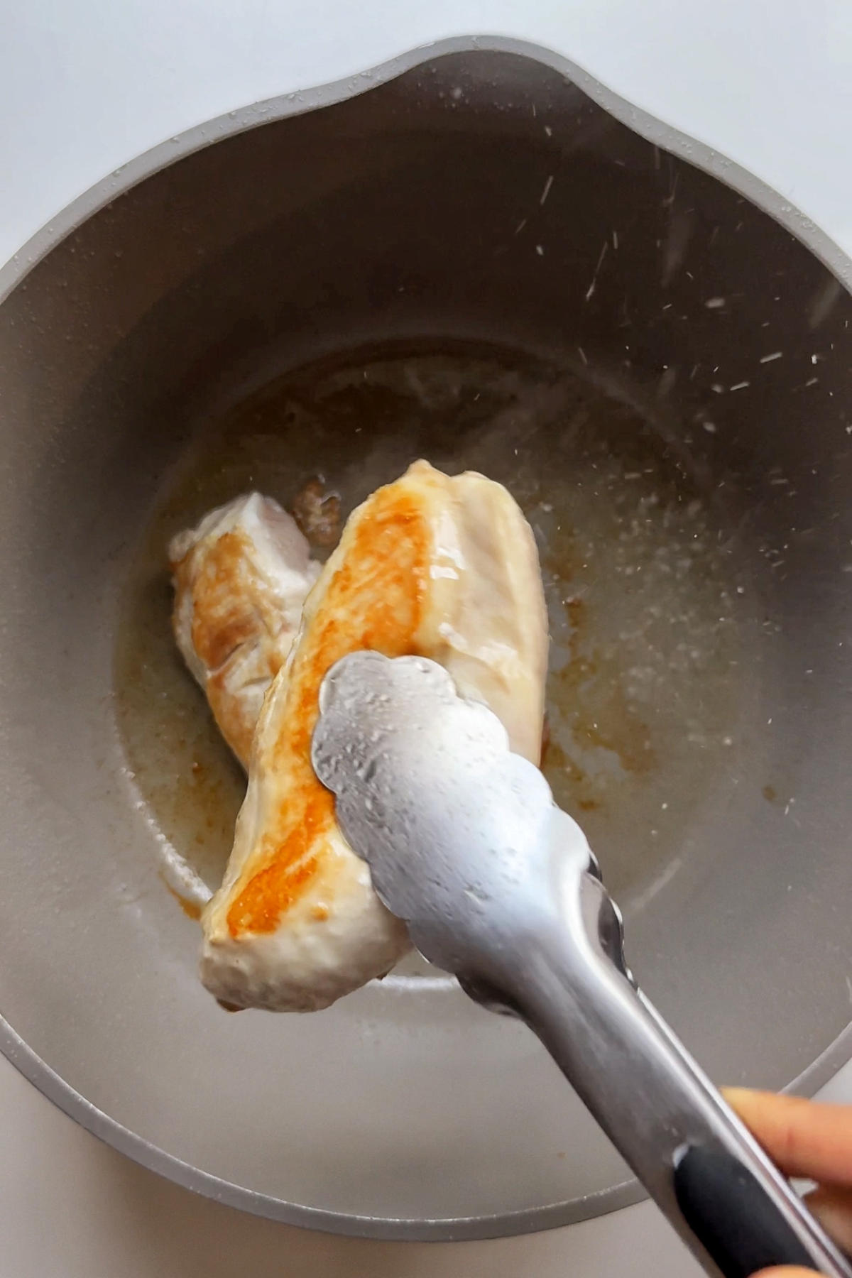Frying chicken breast in a large saucepan.