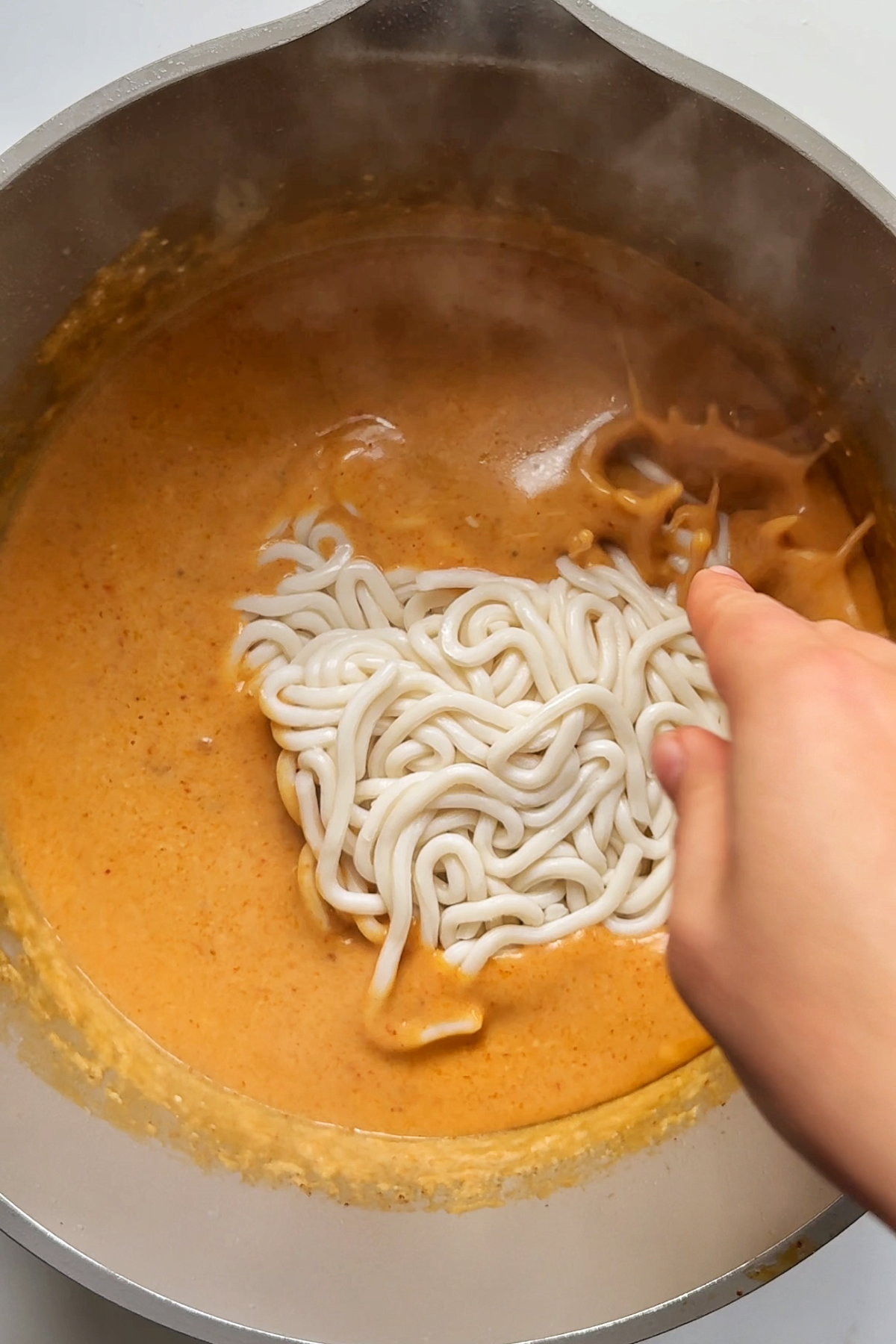 Cooking udon noodles in spicy peanut butter broth