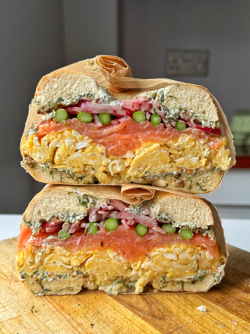 smoked salmon bagels on a chopping board.