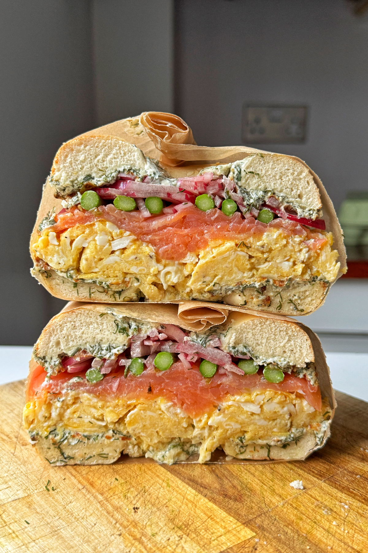 smoked salmon bagels on a chopping board.