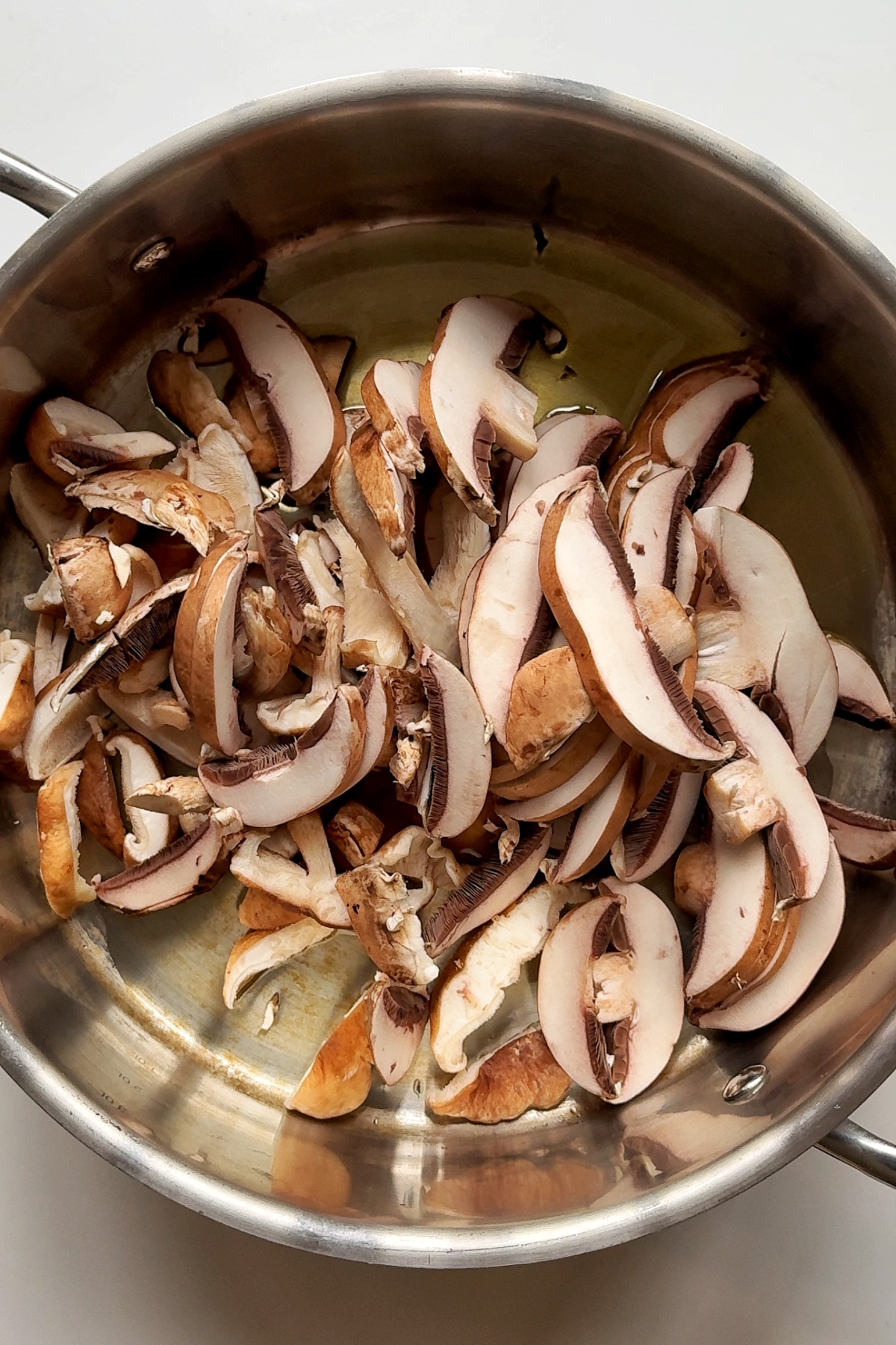 Frying mushrooms in a pan.