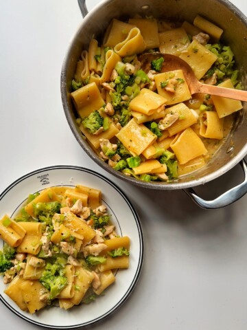Chicken pasta alfredo with broccoli in a pan and bowl.