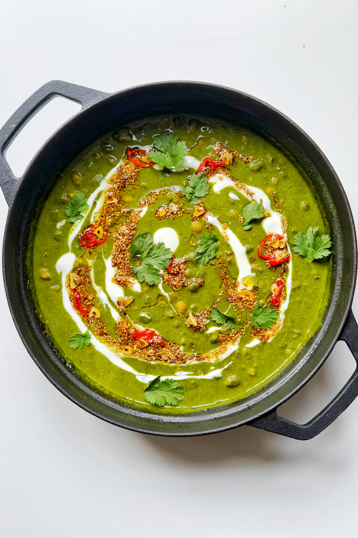 spinach dal in black casserole dish.