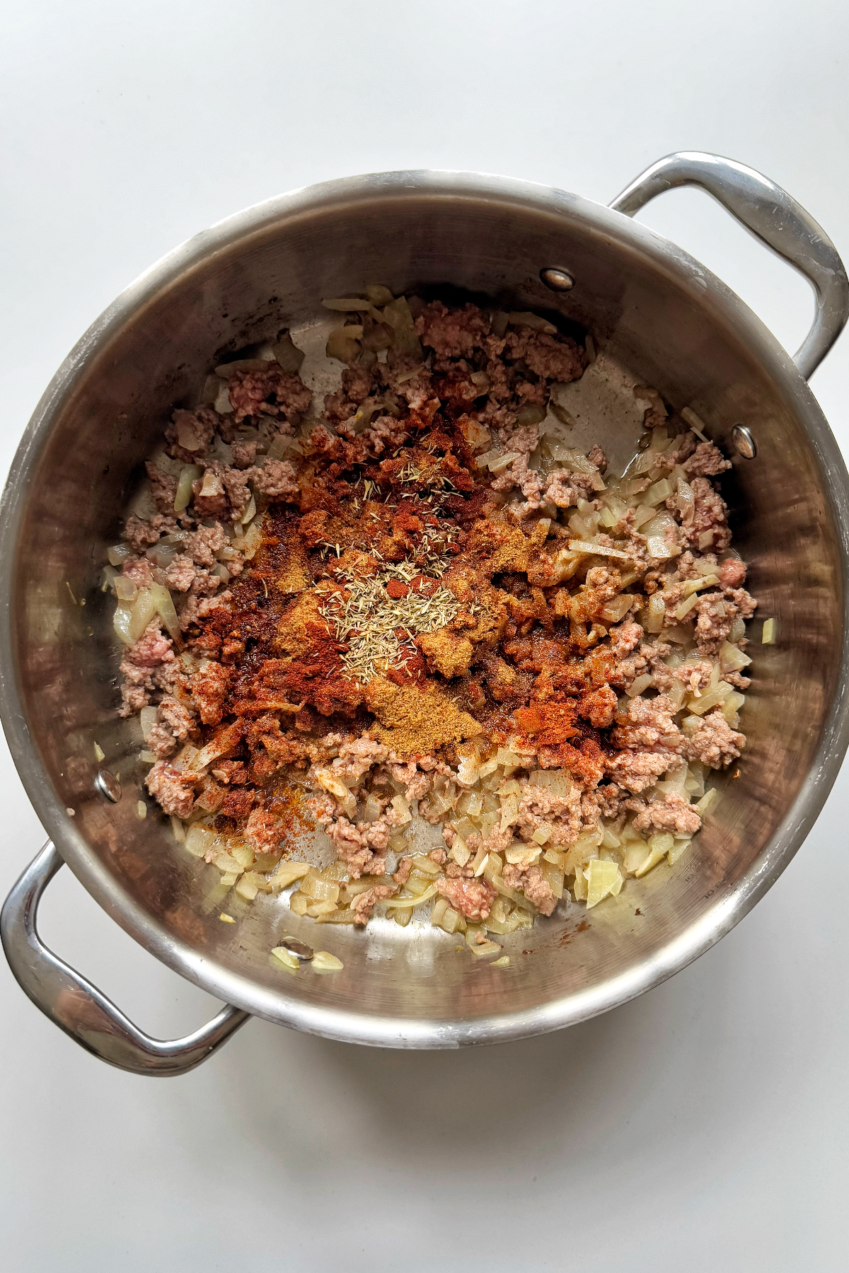 Fry off ground beef with onion, garlic, and seasonings.