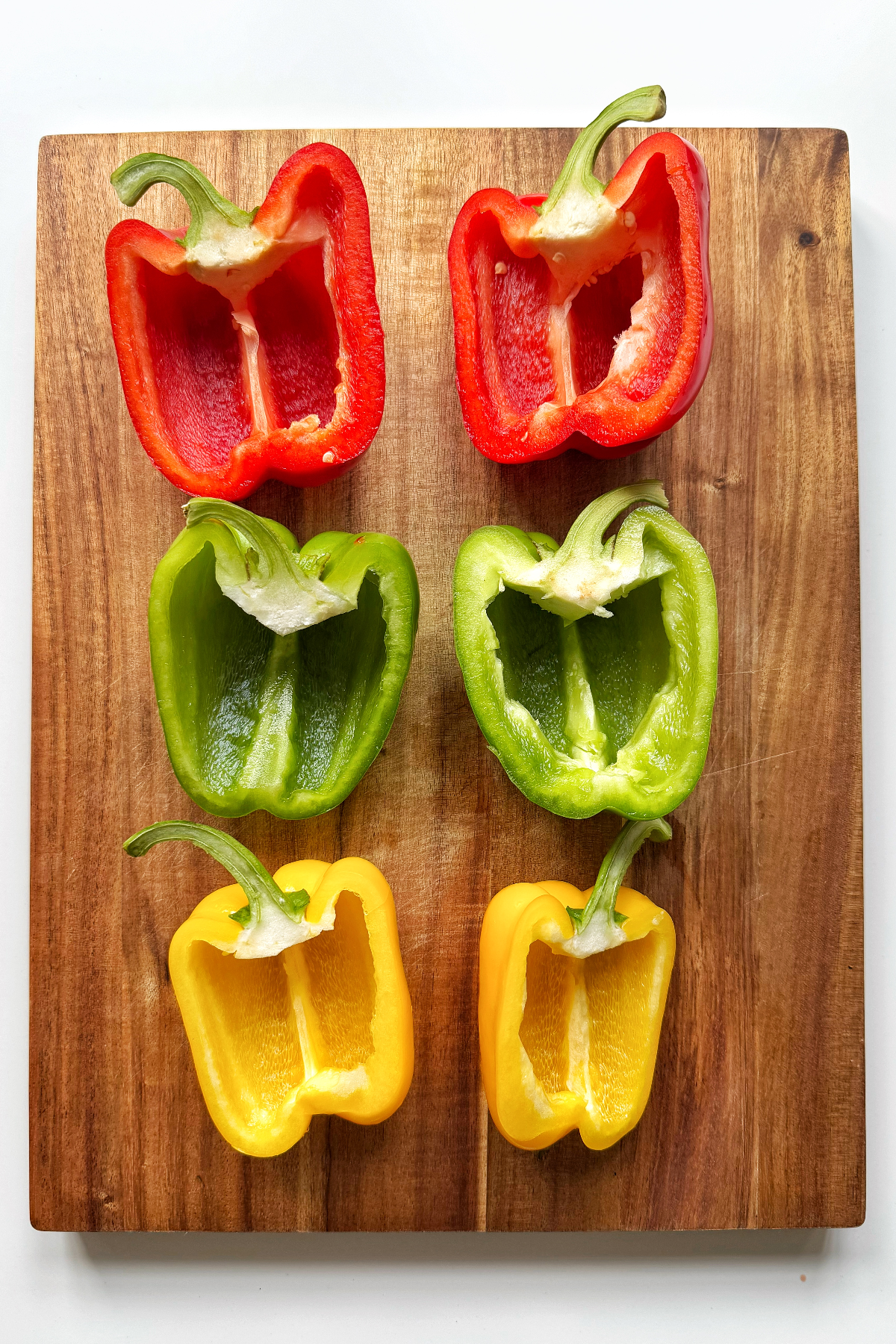 Slicing bell peppers in half.