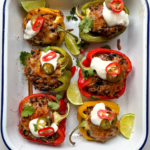 Stuffed Peppers with ground beef and rice in a white tray.