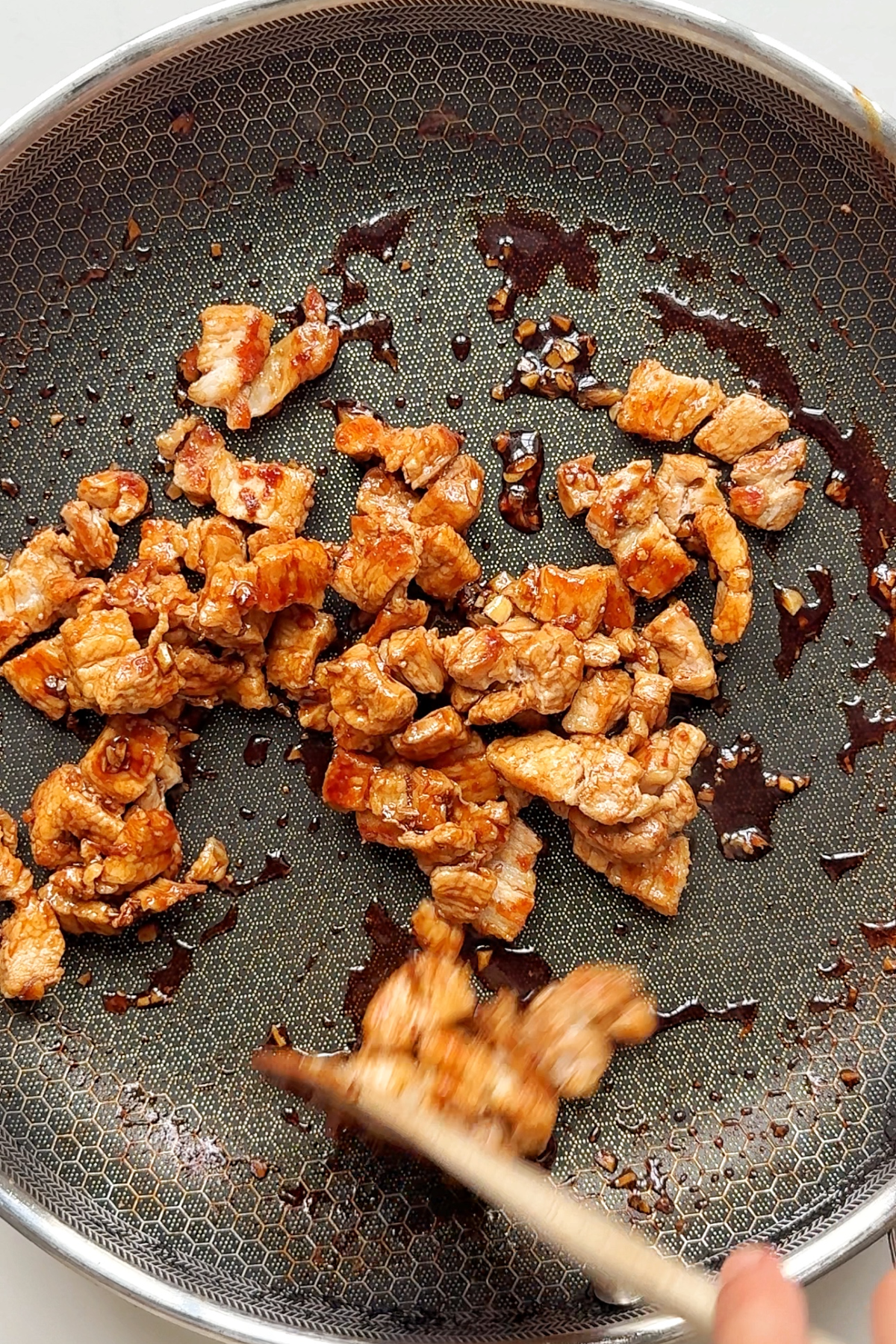 Cooking the pork belly in the Butadon sauce.