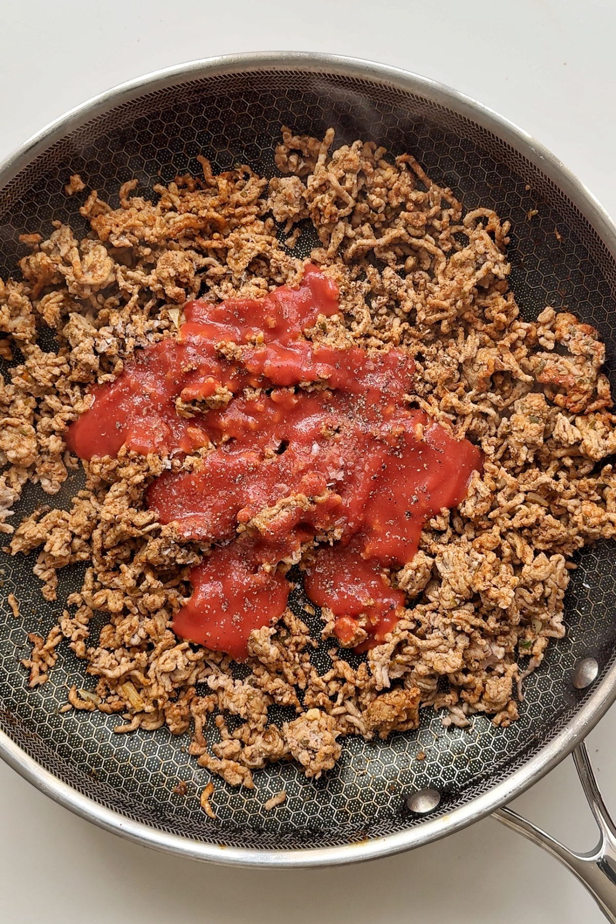 ground pork fried with tomato passata.