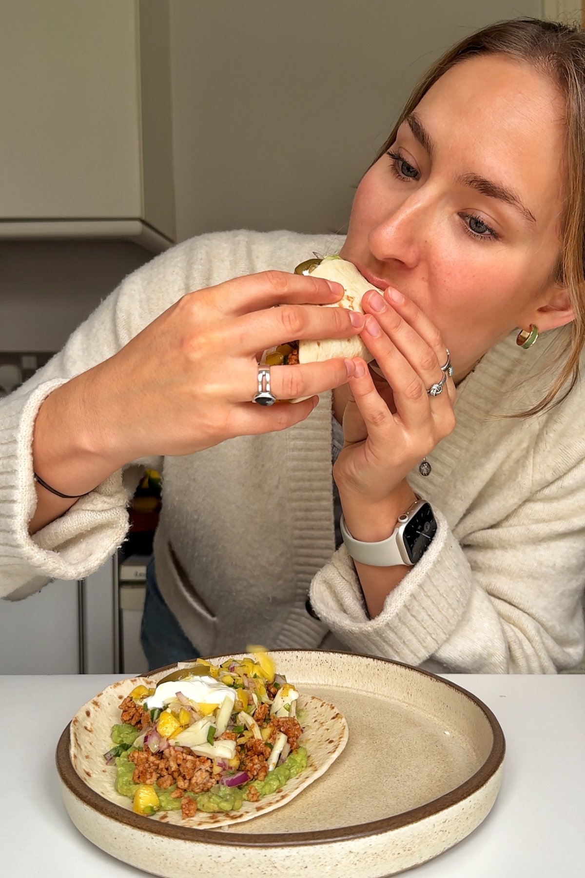 Emily Roz eating ground pork tacos.
