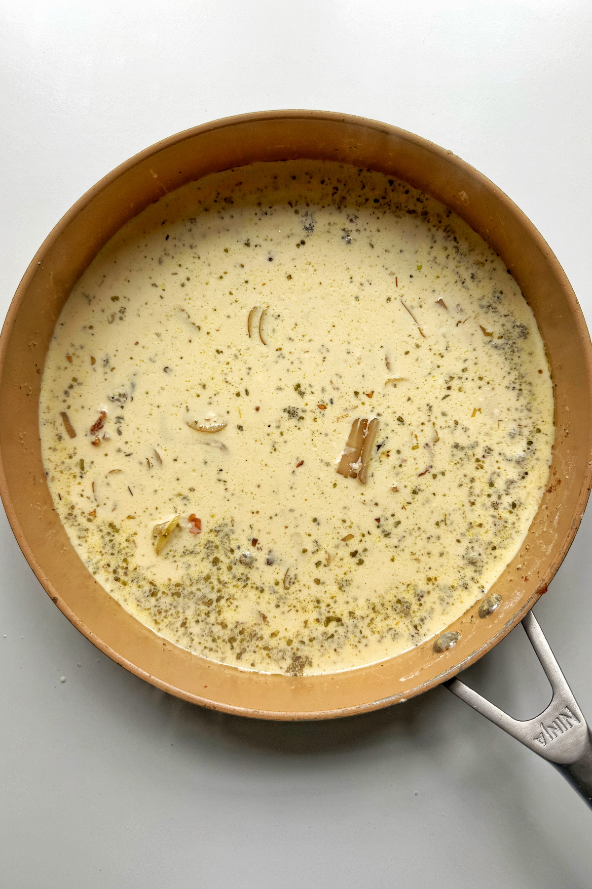 Making the gorgonzola sauce in pan.