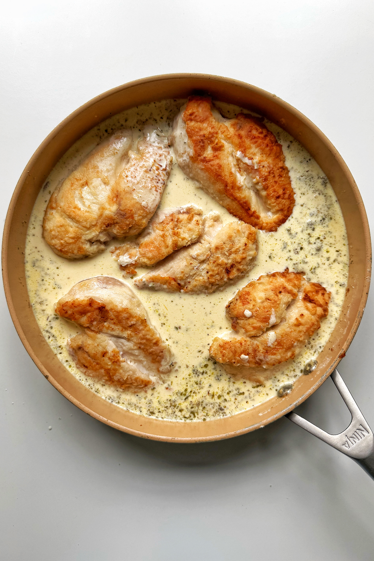 Adding chicken back into the cream sauce.