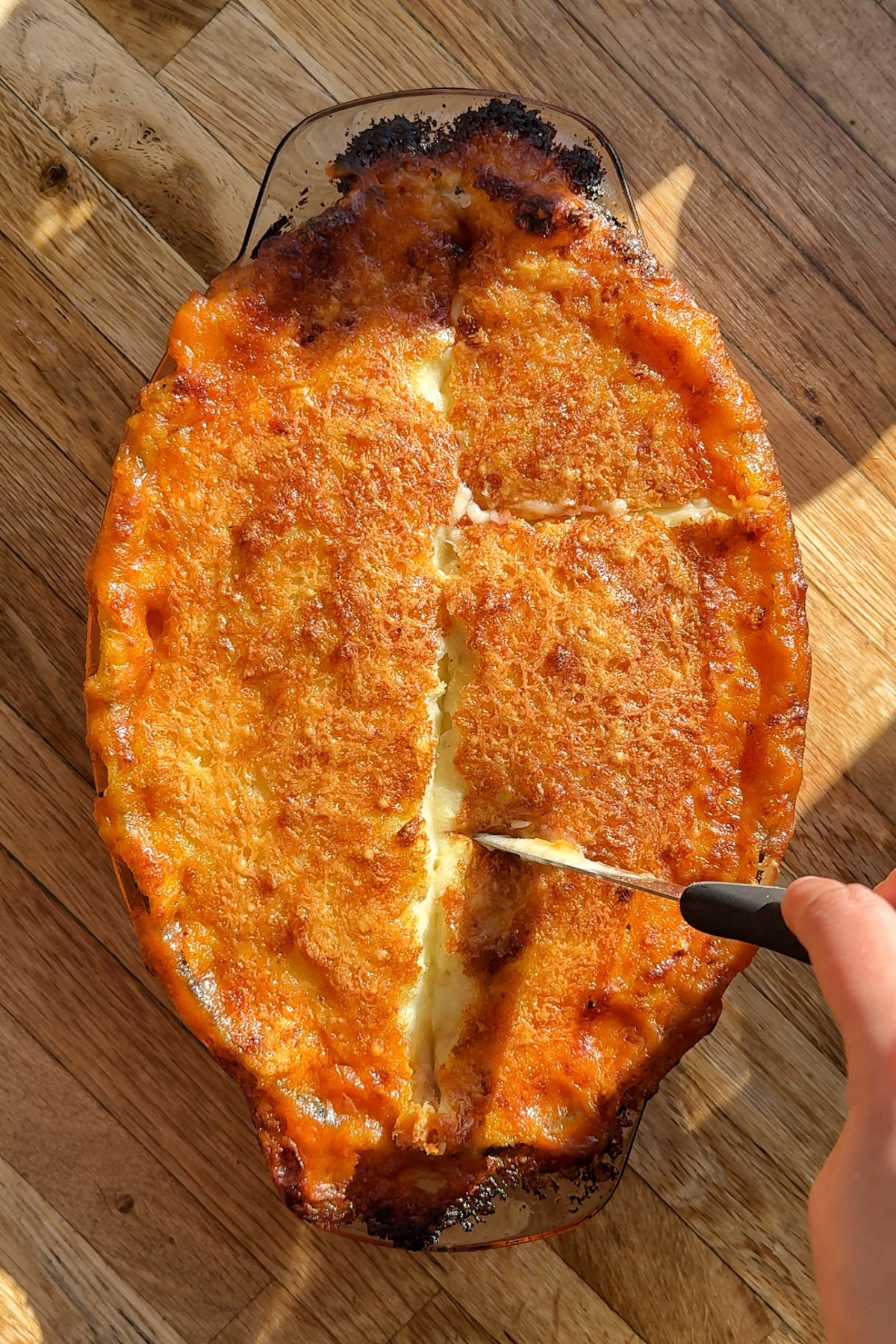 Slicing the shepherd's pie into portions.