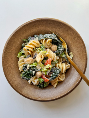 Bean pasta salad in brown bowl.