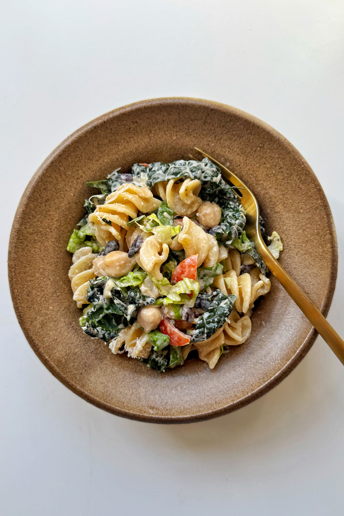 Bean pasta salad in brown bowl.