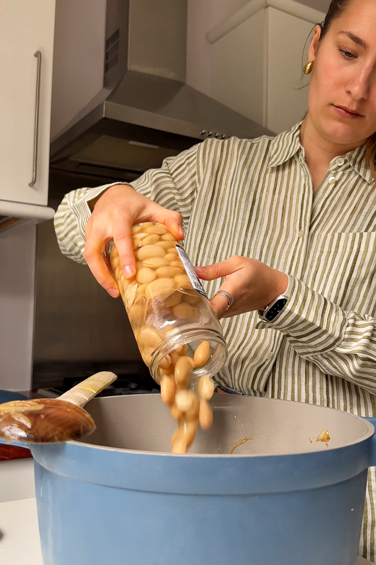 Adding butter beans to the pan.