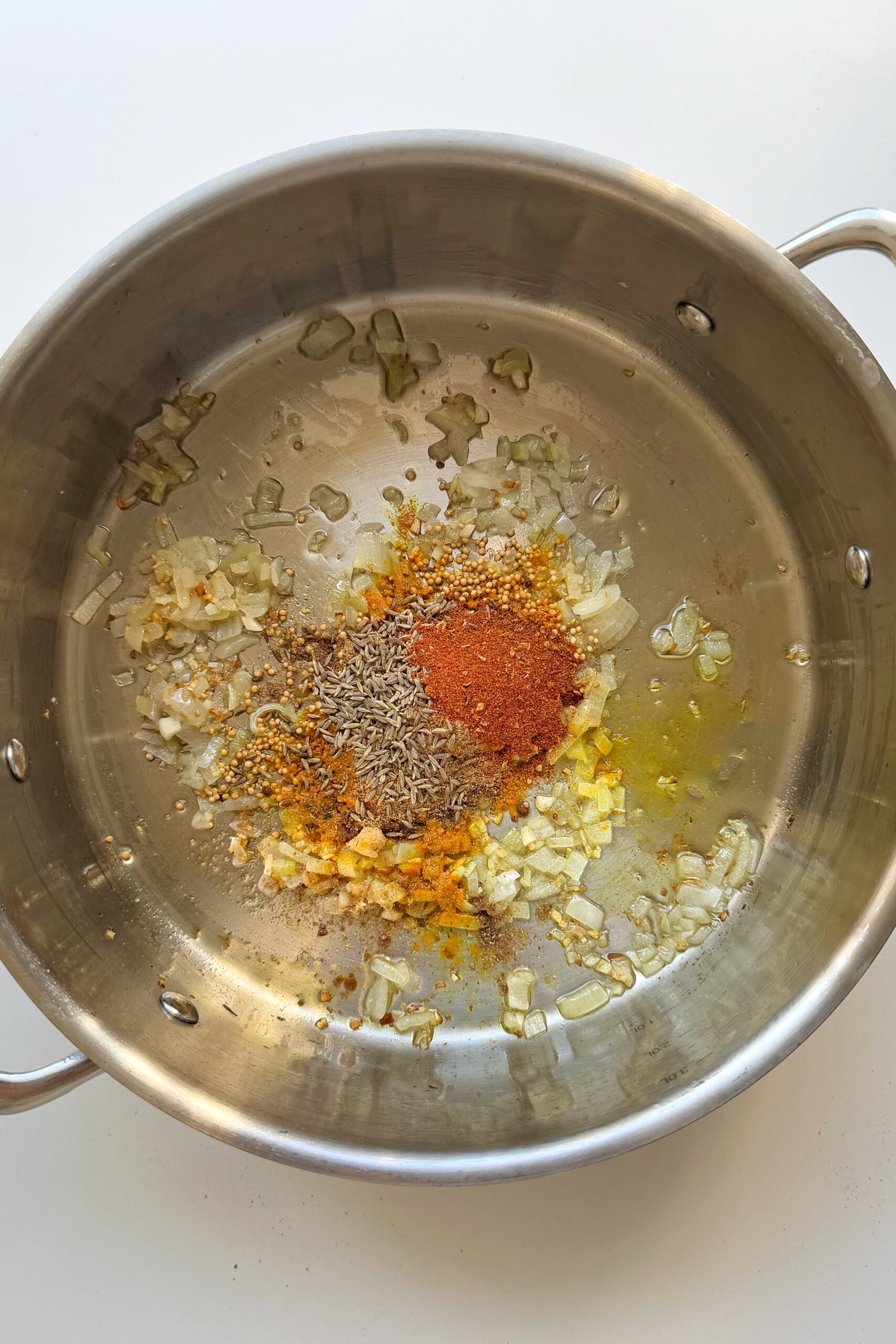 Frying spices in a pan.