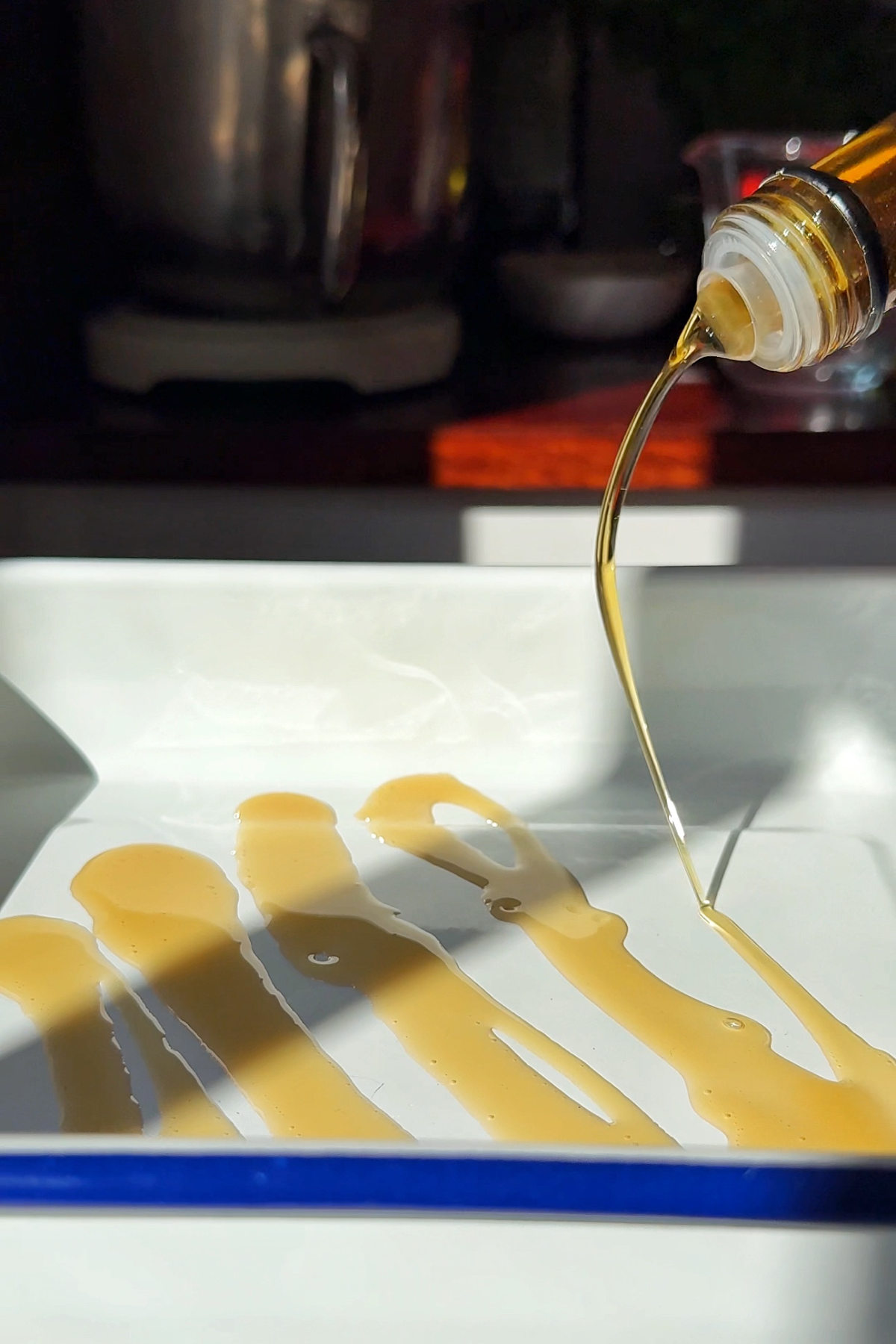 Drizzling oil into pan.