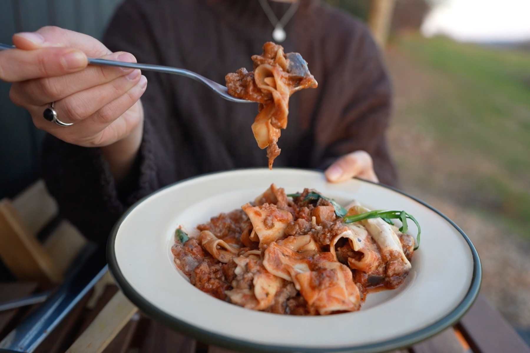 Holding up a spoonful of one pot lasagna.