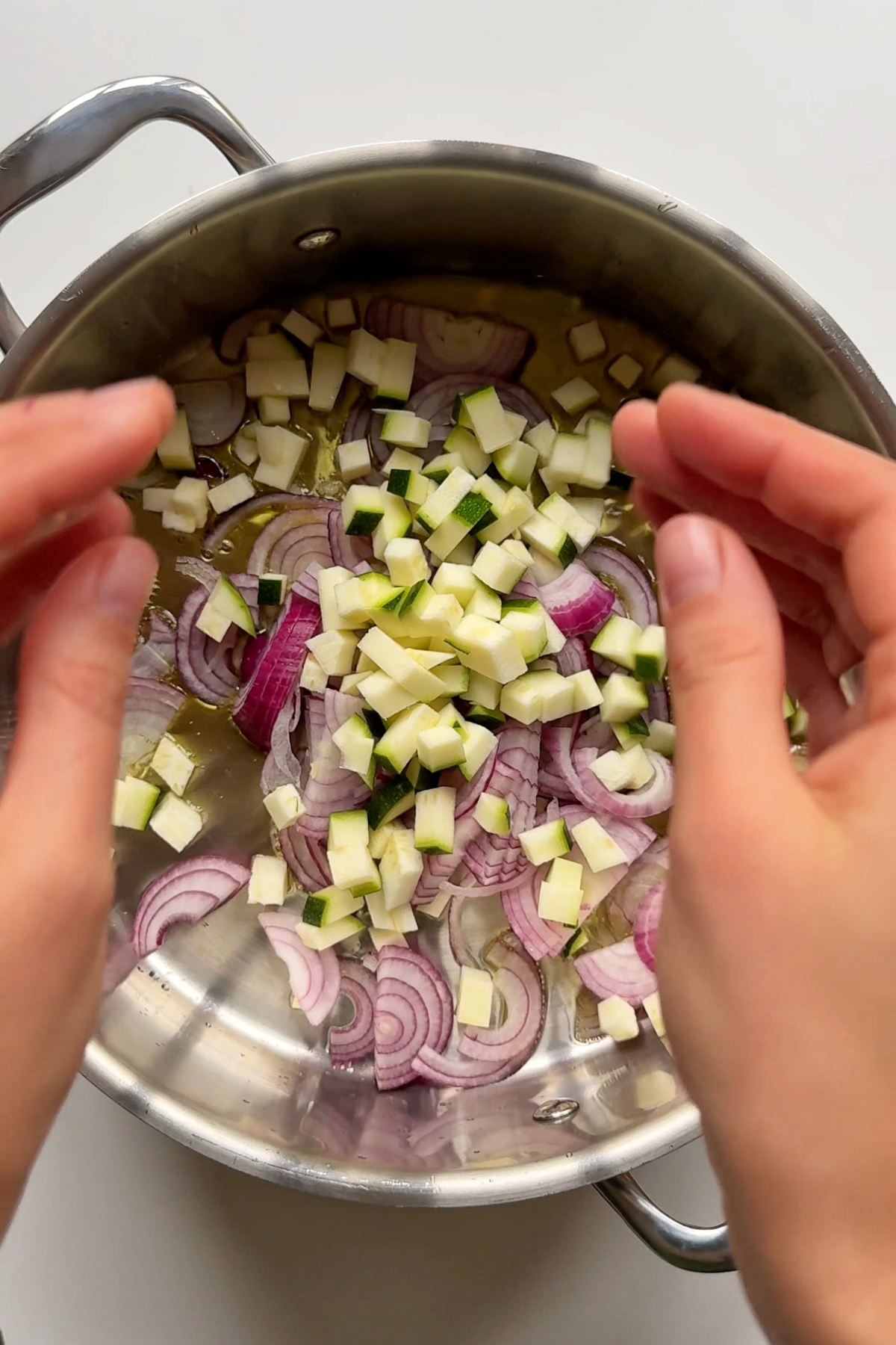 Frying shallots, garlic, and zucchini.