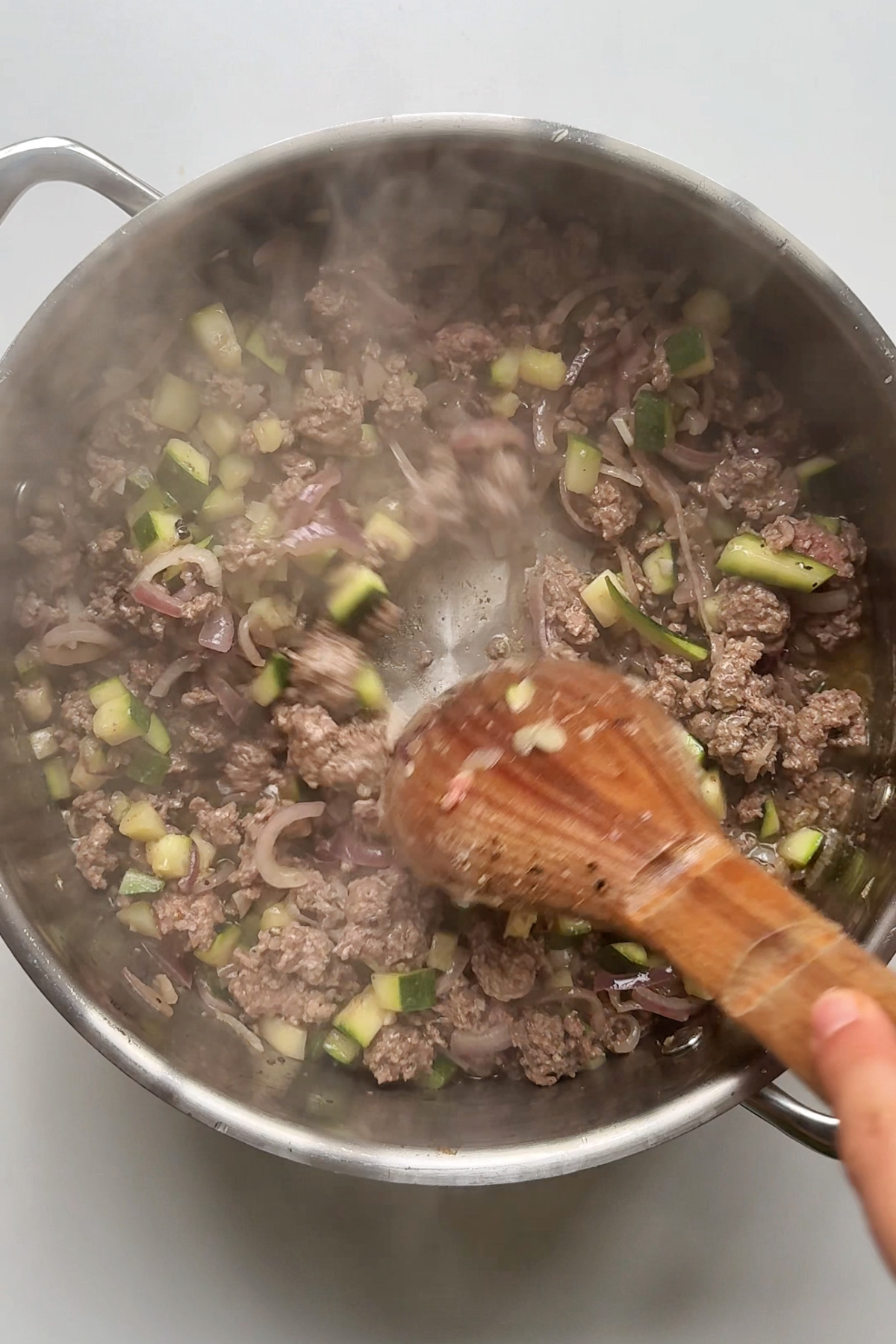 Frying the ground beef in the one pot.