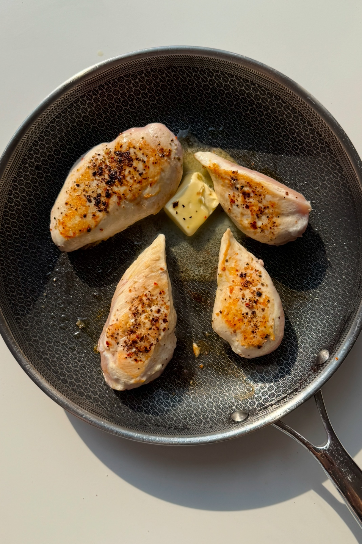 Fry the chicken breast in a pan.