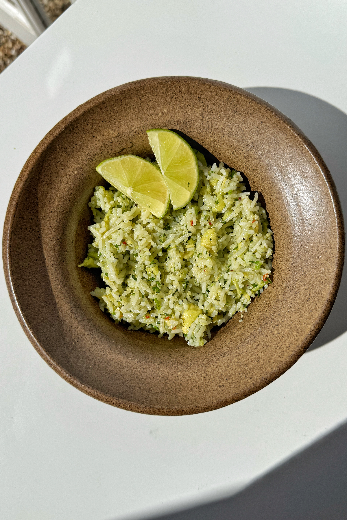 Serving up the avocado rice with lime wedges.