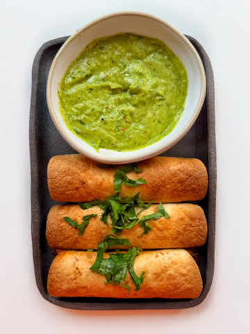 beef and cheese taquitos with an avocado sauce.
