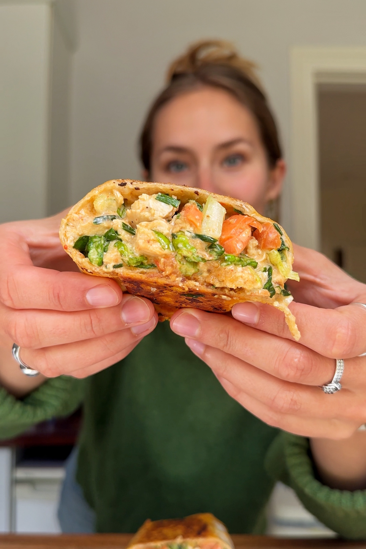 Emily holding up a buffalo chicken wrap.