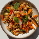 Butter bean salad in a bowl with a fork.
