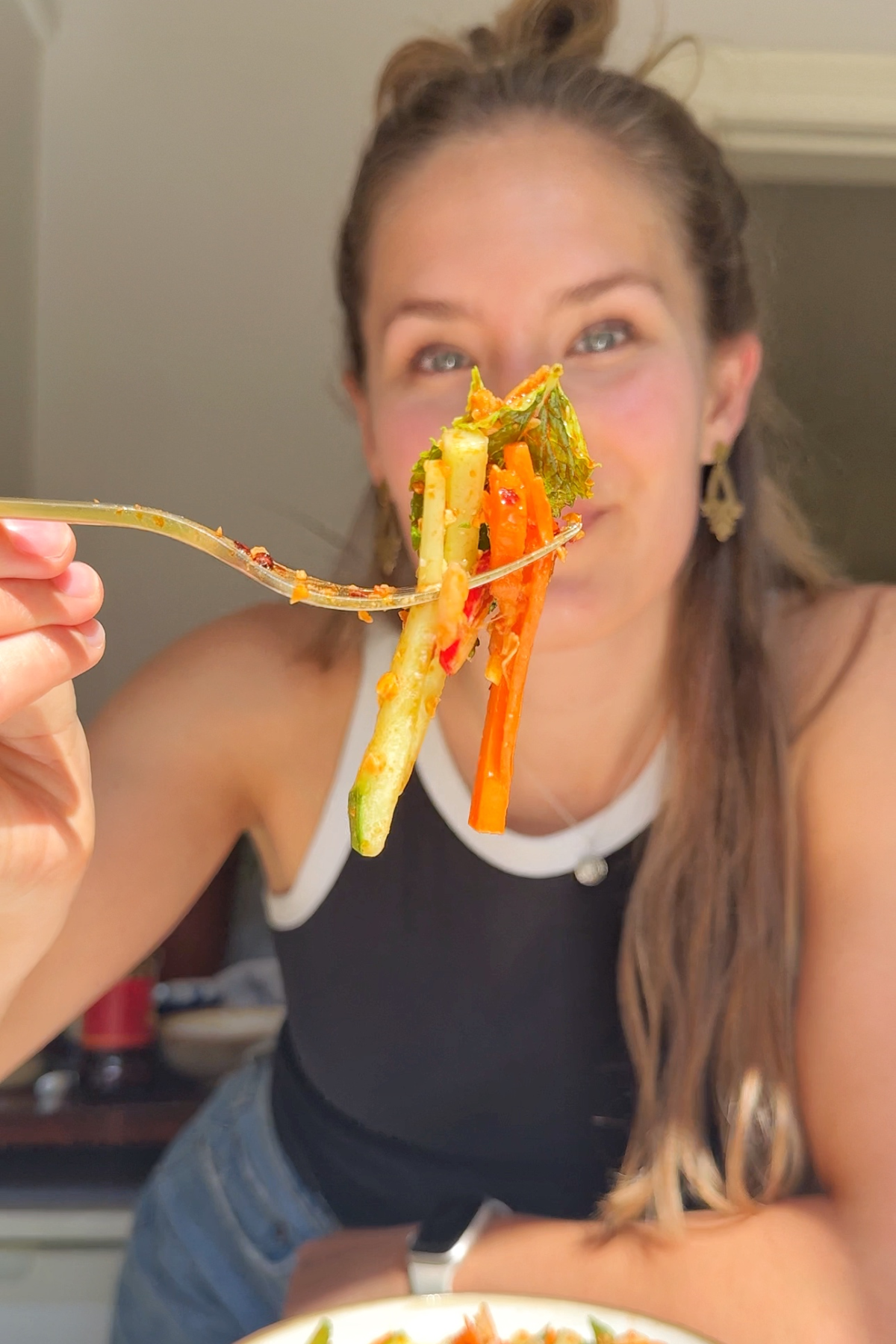 Emily holding butter bean salad up to the camera.