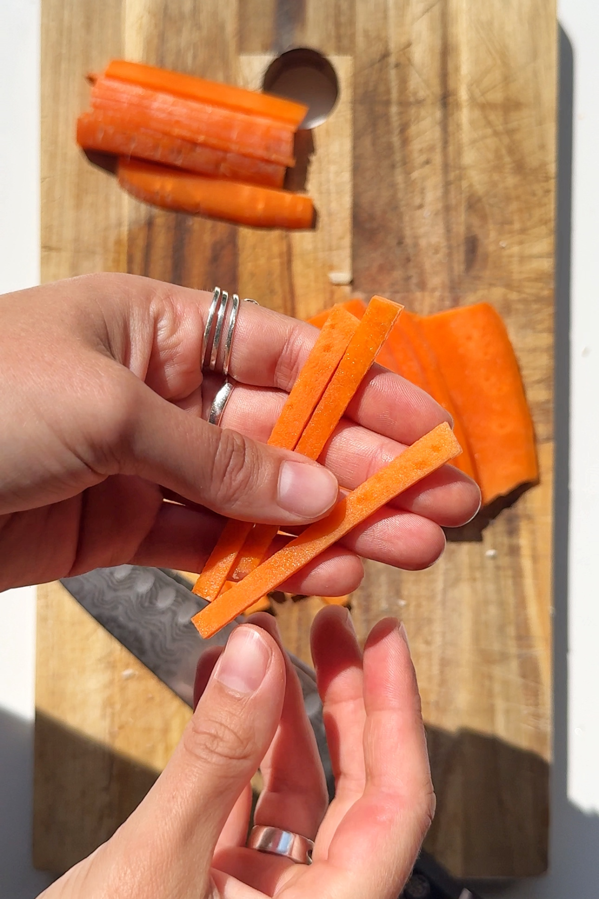 Chopping carrots into batons.