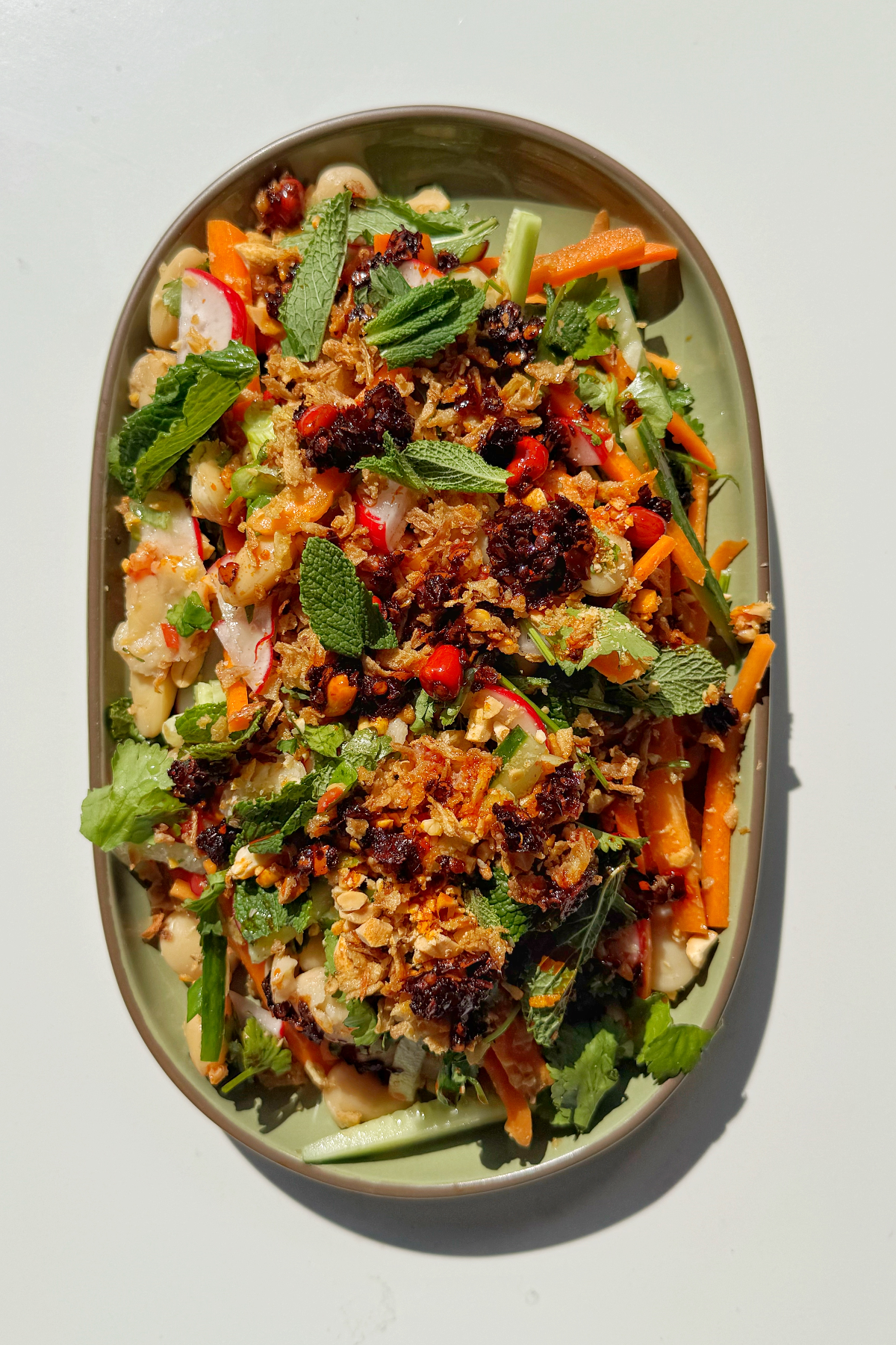 Butter bean salad with chilli oil on a plate.