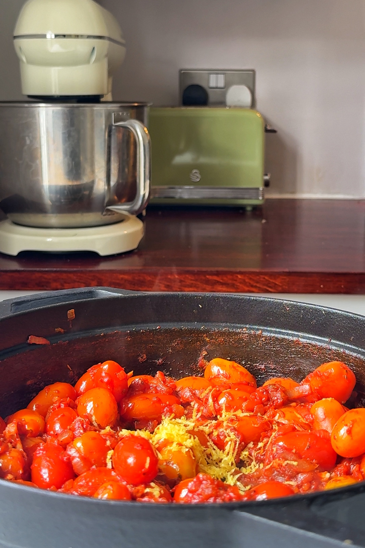 Frying tomato with lemon zest.