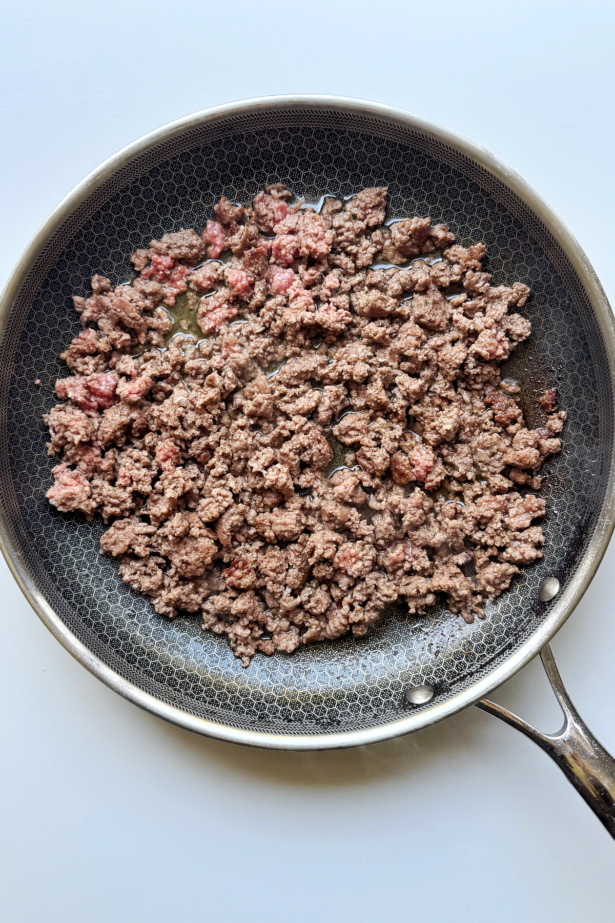 Frying ground beef in a pan.