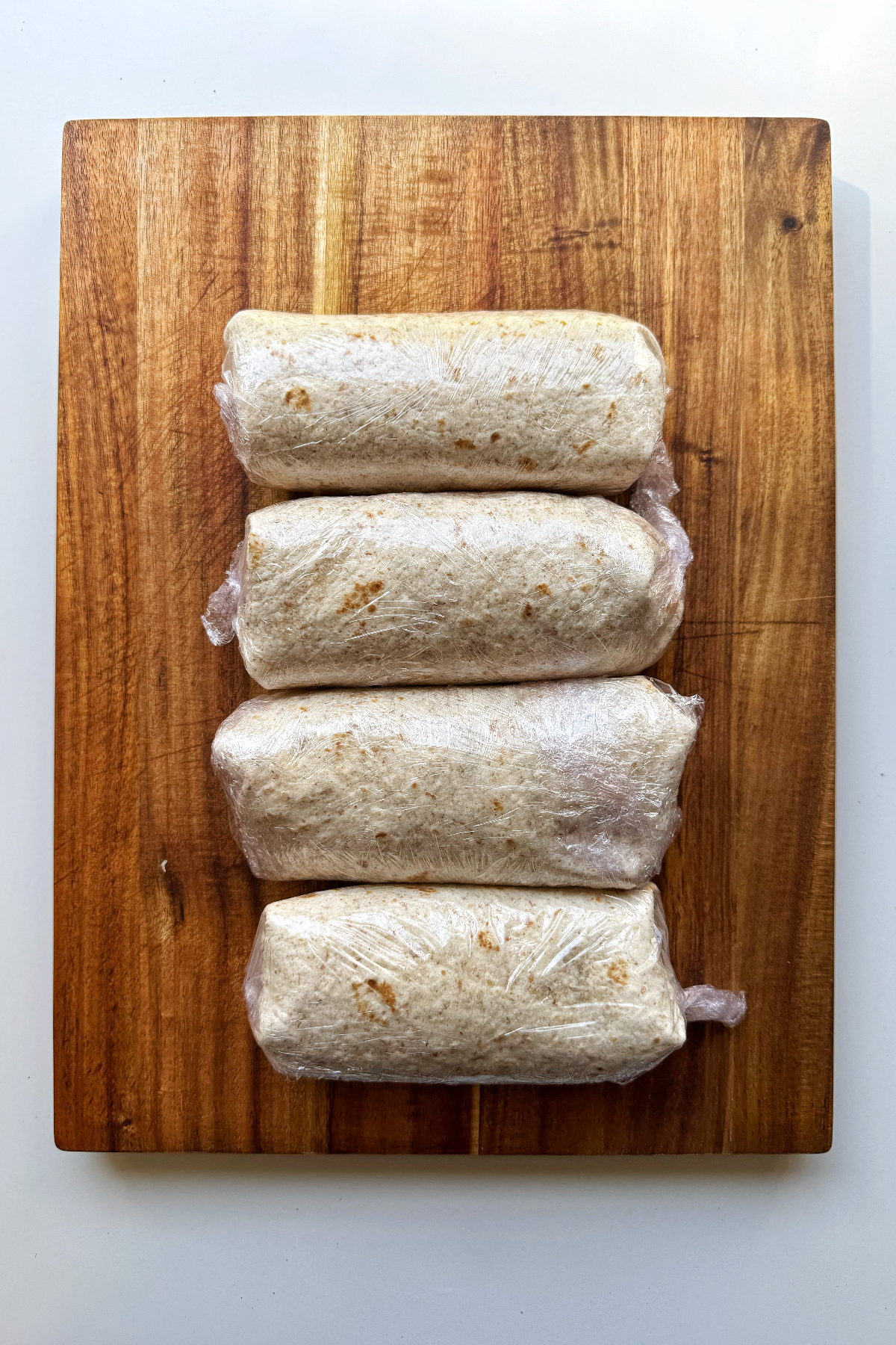 the final four burritos wrapped in cling film.