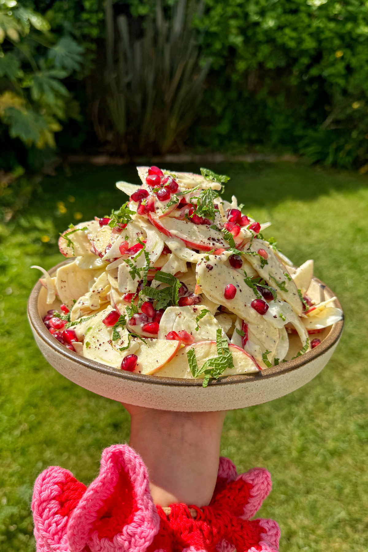 apple and fennel salad held up by hand.