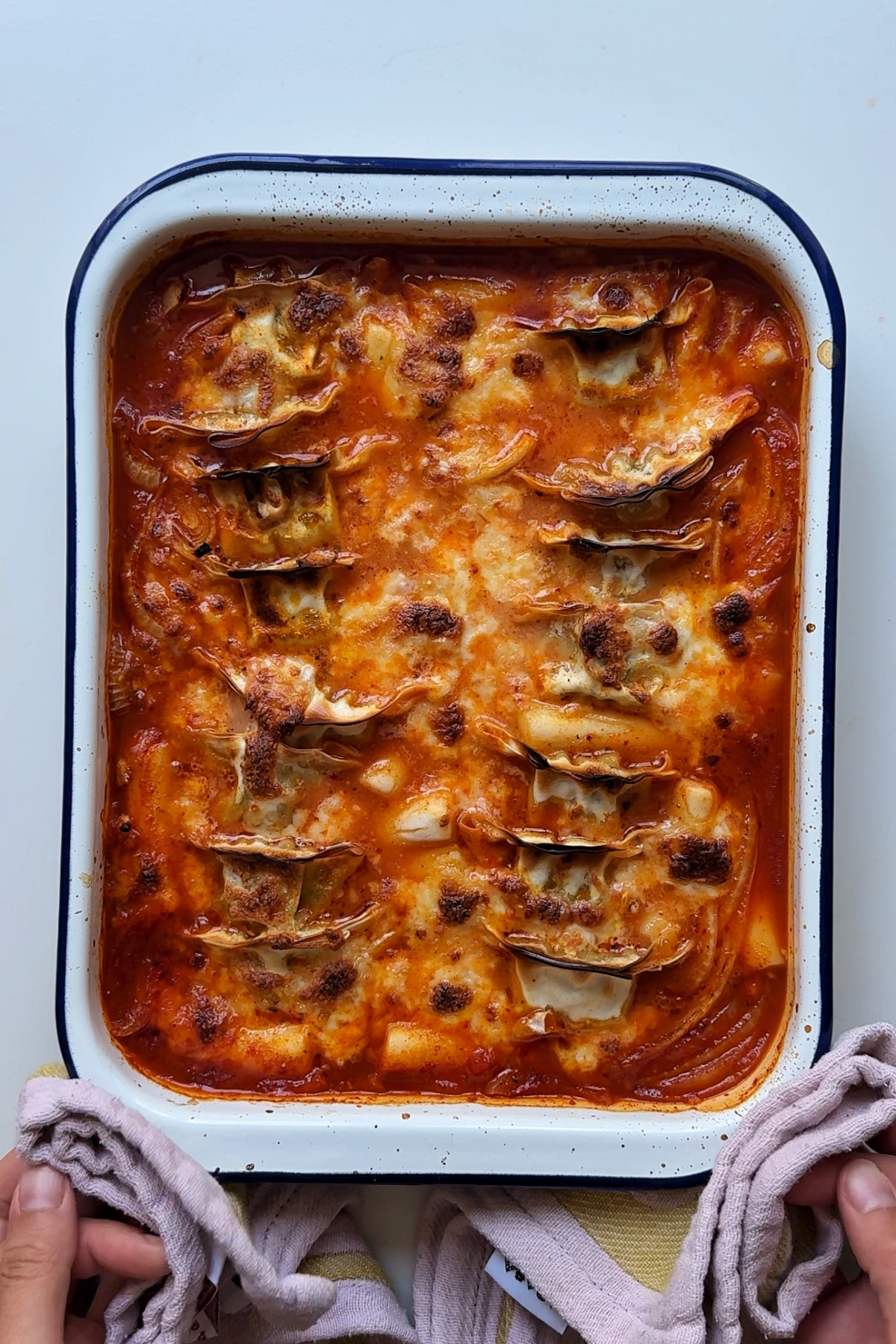Cooked baked dumpling rice cake bake with melted cheese on the top.