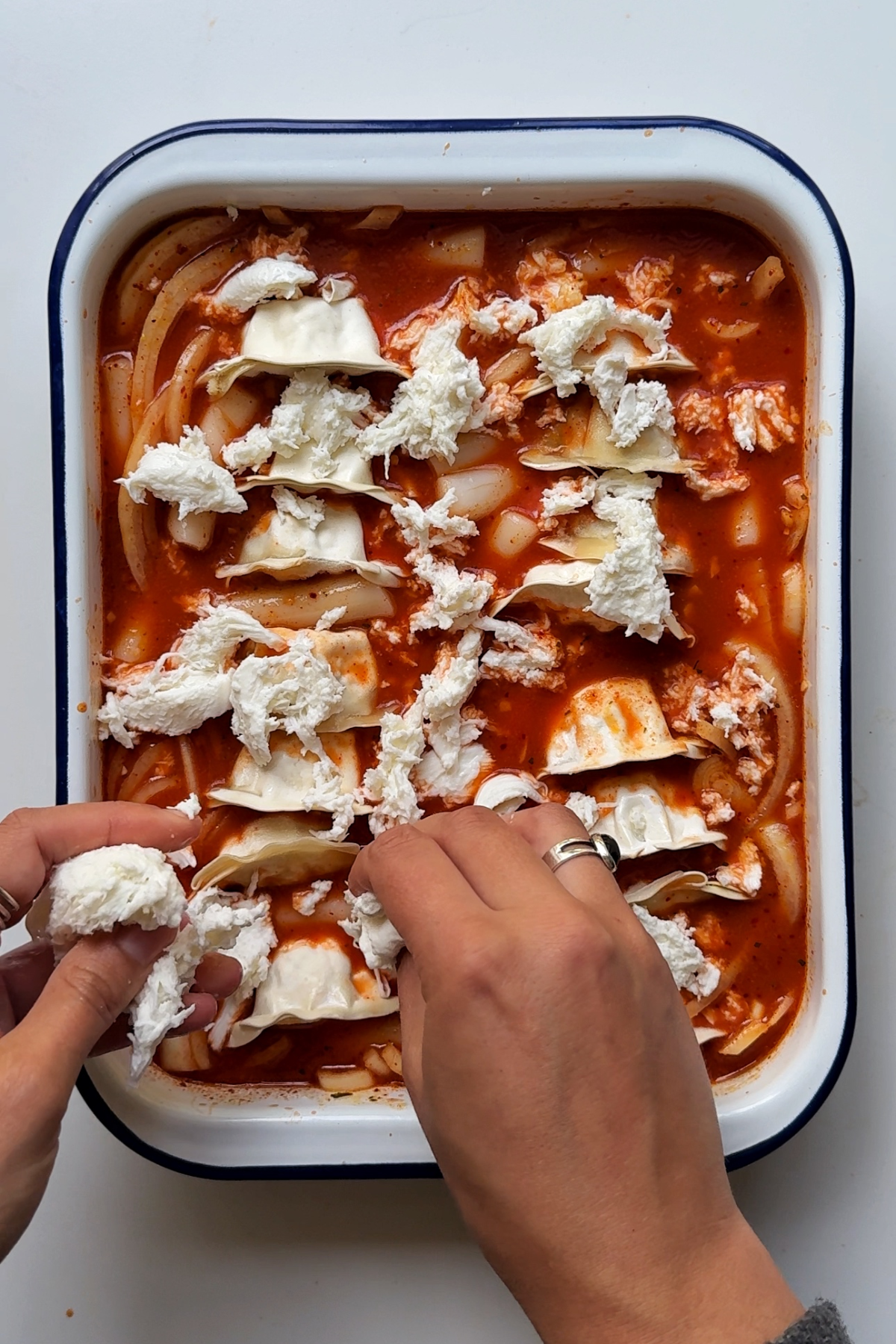 Adding the elements to the dumpling rice cake bake.