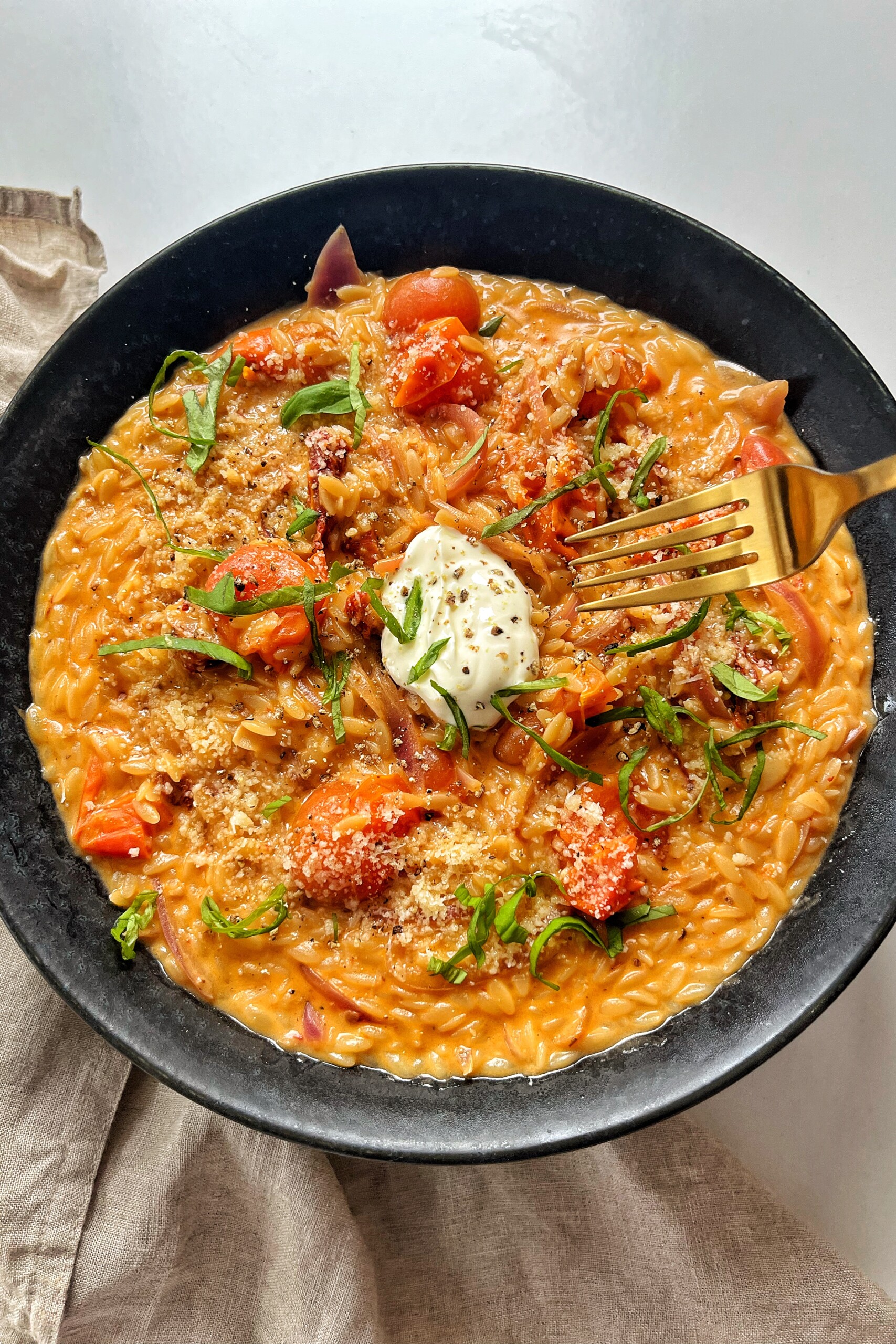 Tomato Orzotto in one black pot