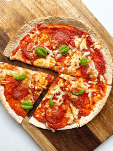 pizza wrap on wooden chopping board.