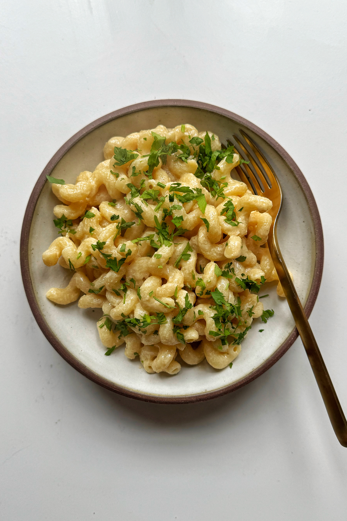 Tahini pasta in white bowl with fork.