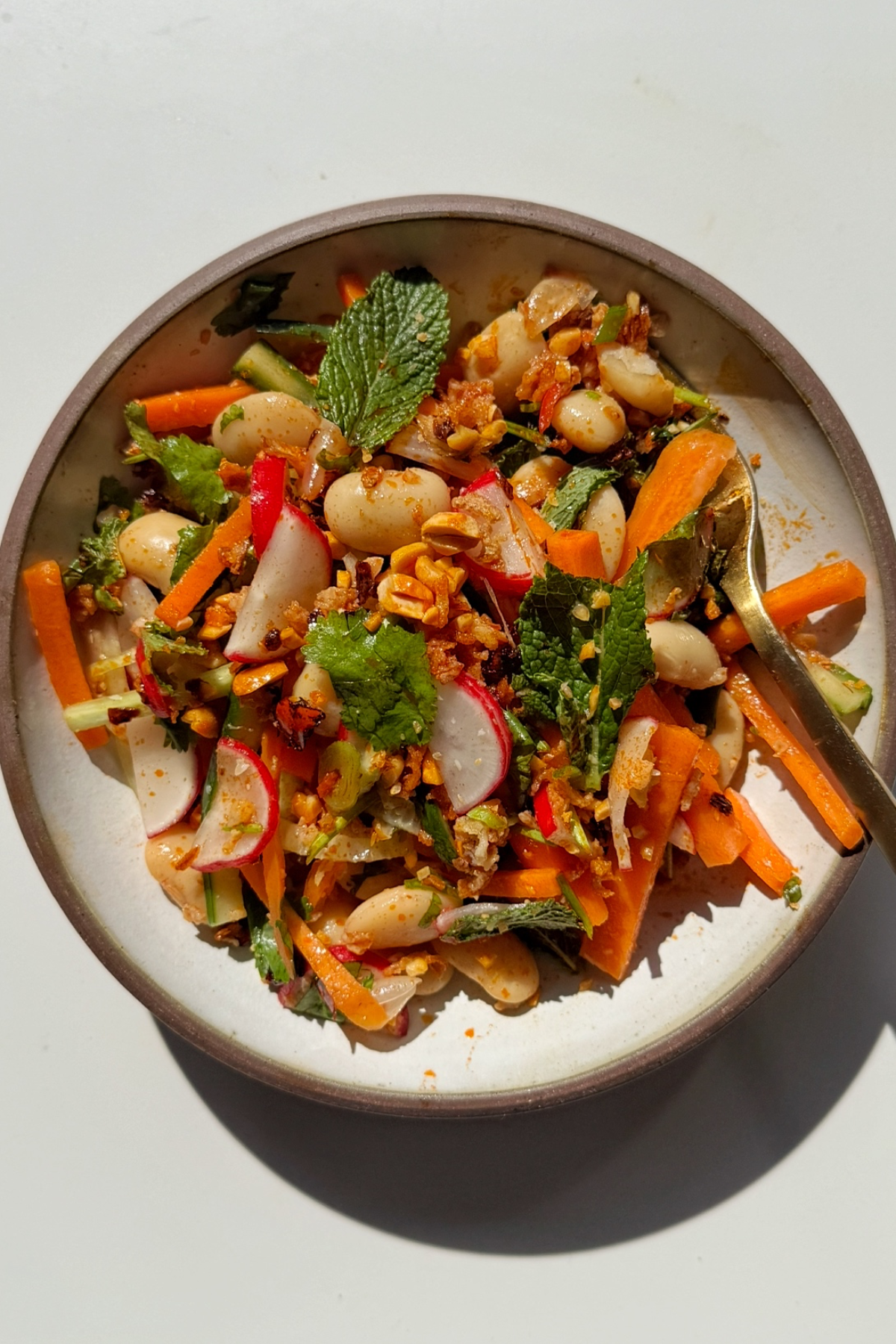 butter bean salad in a white bowl.